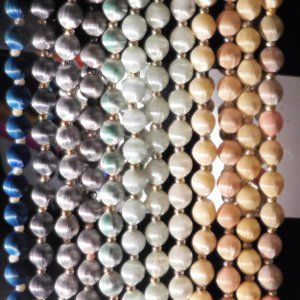 12 SETS OF NYLON BEADS.